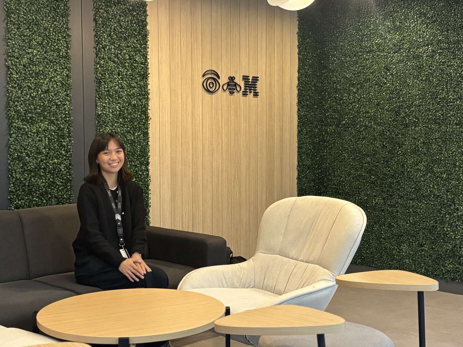 Georgette Dalen seated by the IBM logo at the IBM office