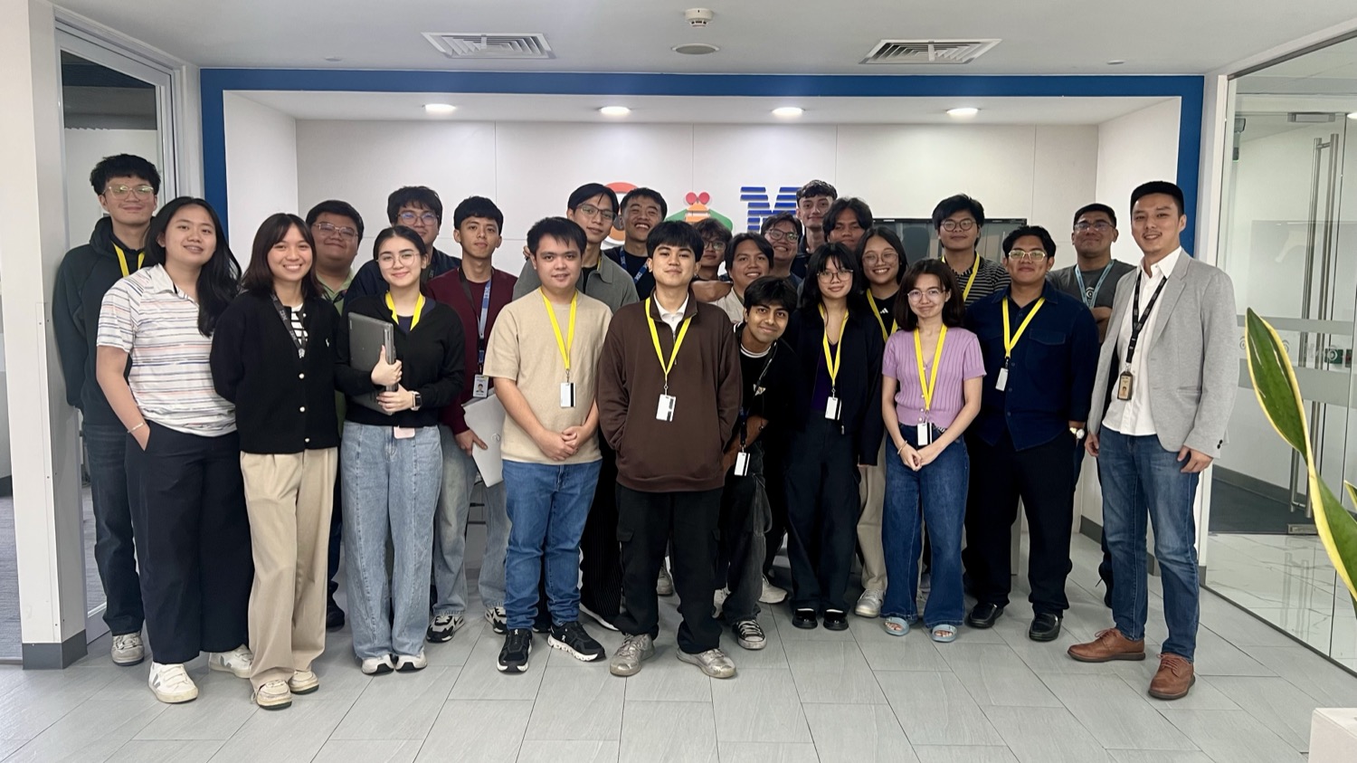 The intern cohort in front of the IBM logo wall